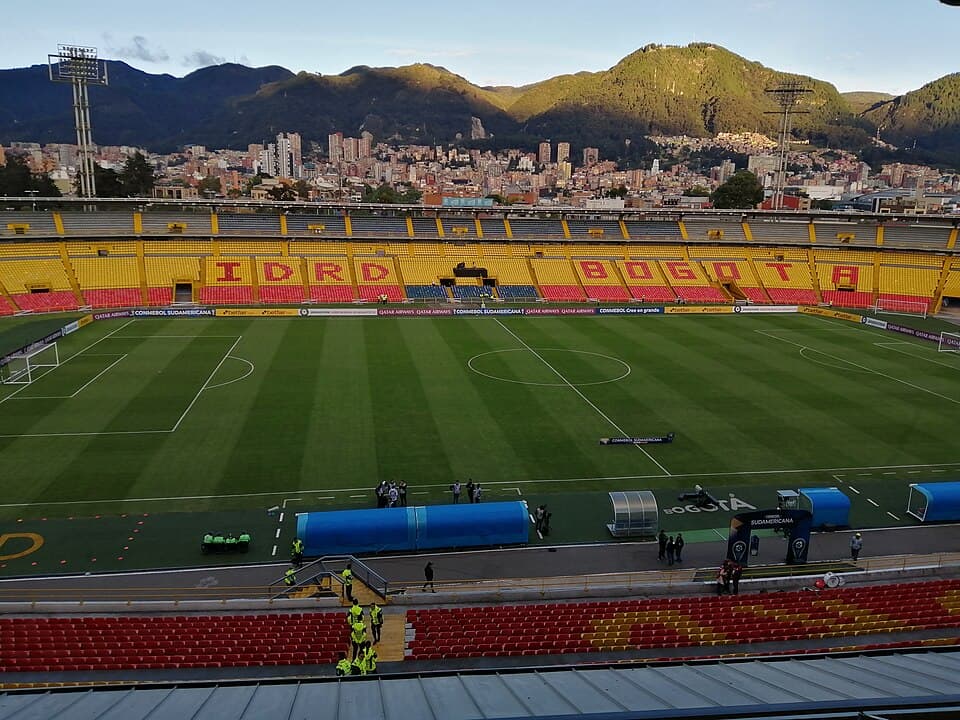 A football stadium with red seats before the match between Independiente Santa Fe and Jaguares de Córdoba