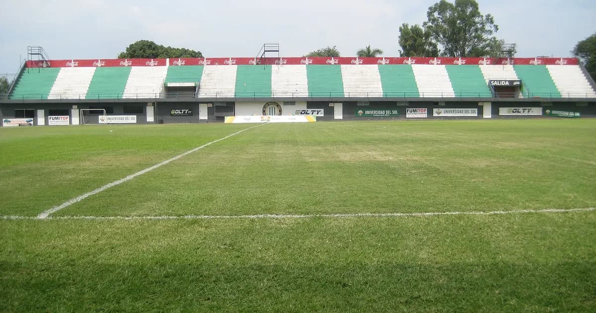 Paraguayan football stadium with green pitch and stands ready for Rubio Ñú vs Olimpia match